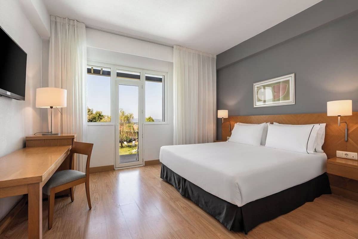 Deluxe Double Room, Balcony | Minibar, desk, laptop workspace, blackout drapes