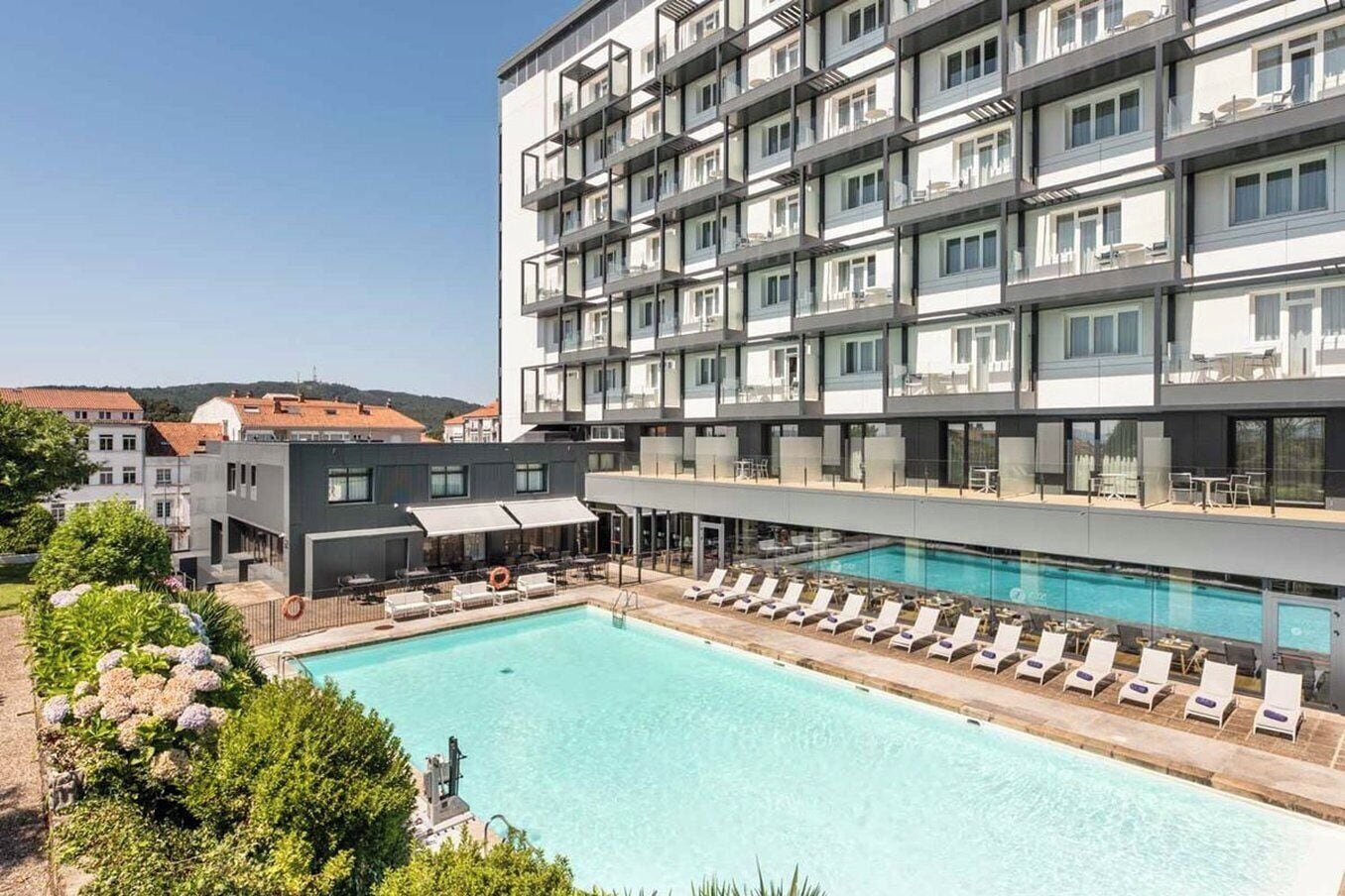 Una piscina al aire libre de temporada, sombrillas