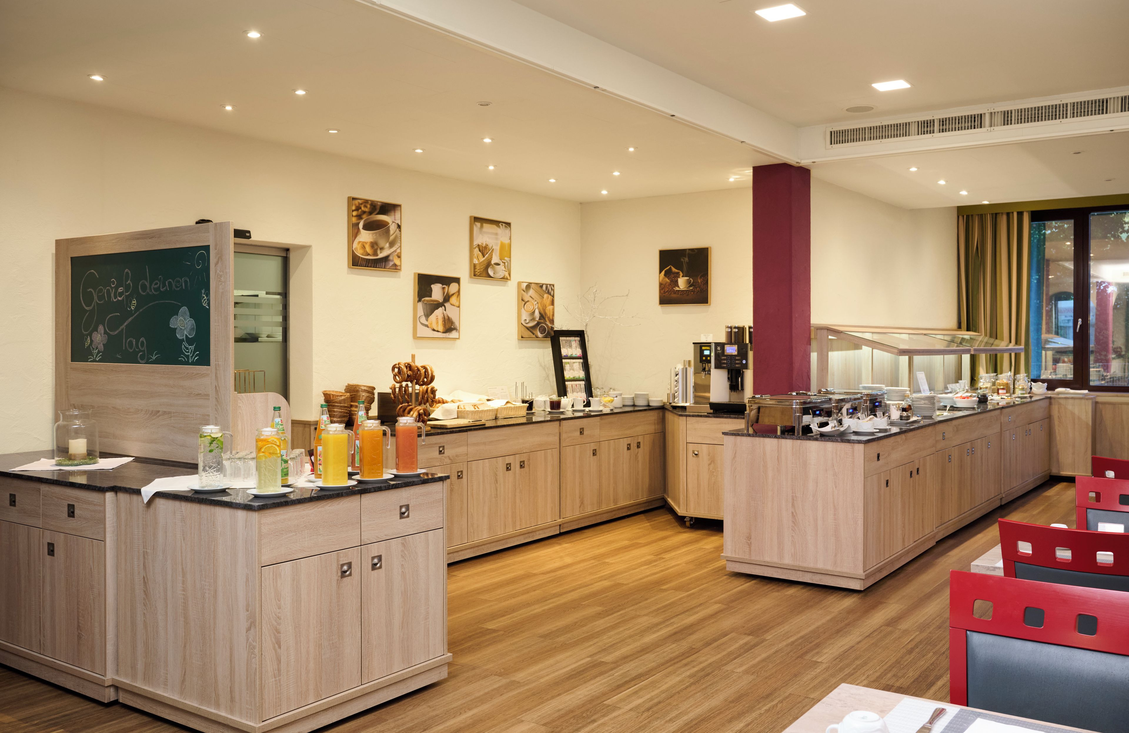 A modern kitchen with wooden cabinets, a chalkboard, and various breakfast items.