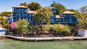 A multi-story hotel with balconies overlooking a body of water.