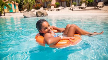 Relax by the serene pool, surrounded by lush greenery and comfortable lounge chairs.