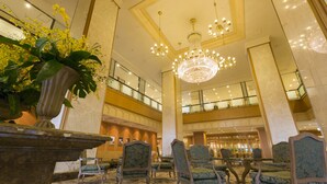 A spacious lobby with a grand chandelier, multiple seating areas, and a large potted plant. - Hotel Agora Regency Osaka Sakai (Sakai)