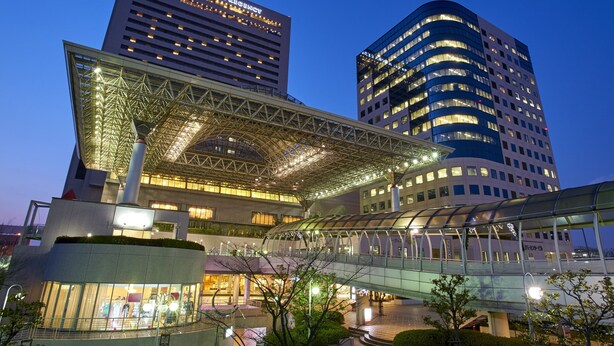 A modern hotel with a glass facade, a covered walkway, and adjacent high-rise buildings. - Hotel Agora Regency Osaka Sakai (Sakai)