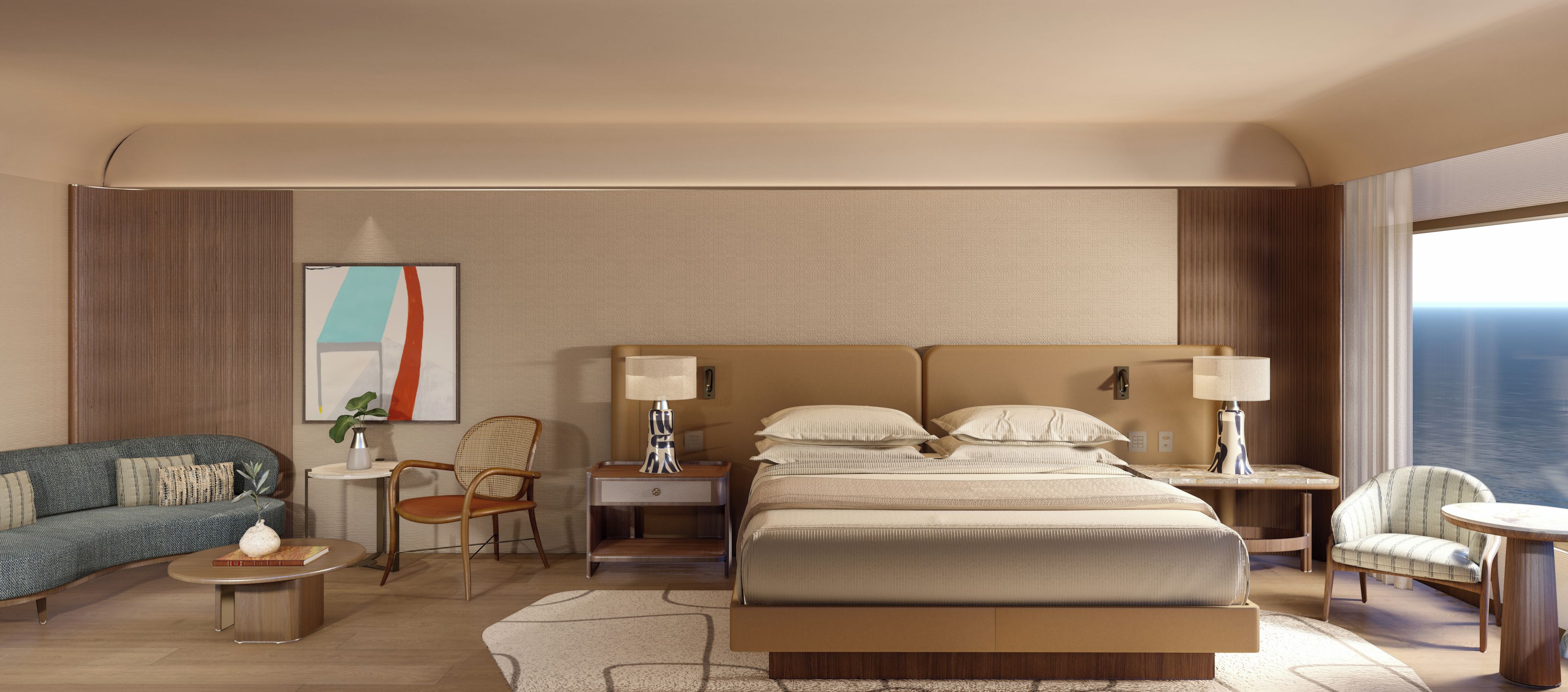 Quarto de hotel com uma cama grande, duas mesas de cabeceira, um sofá, uma poltrona e uma pequena mesa com abajur.