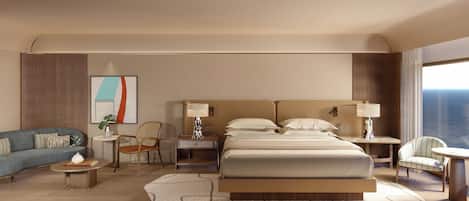 A hotel room with a large bed, two bedside tables, a sofa, a chair, and a small table with a lamp.