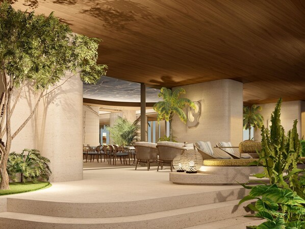 A modern indoor space with a central seating area, a staircase, and a dining setup. - Sofitel Rio de Janeiro Ipanema (Rio de Janeiro)