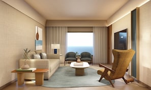 Une chambre d’hôtel moderne, dotée d’un canapé, de fauteuils, d’une table basse et offrant une vue sur l’océan.