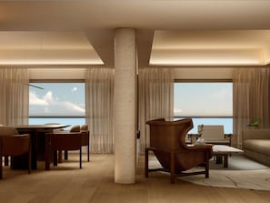 A modern living room with a large window, a dining area, and a seating arrangement. - Sofitel Rio de Janeiro Ipanema (Rio de Janeiro)