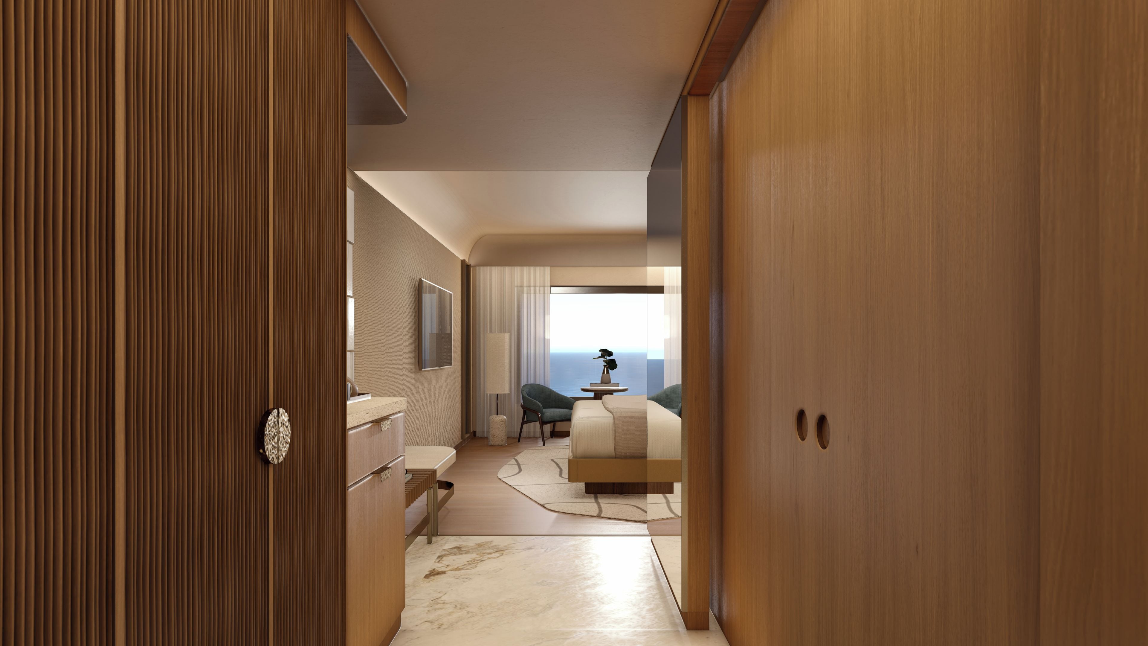 Habitación de hotel con cama, una silla, un escritorio y vistas al mar.