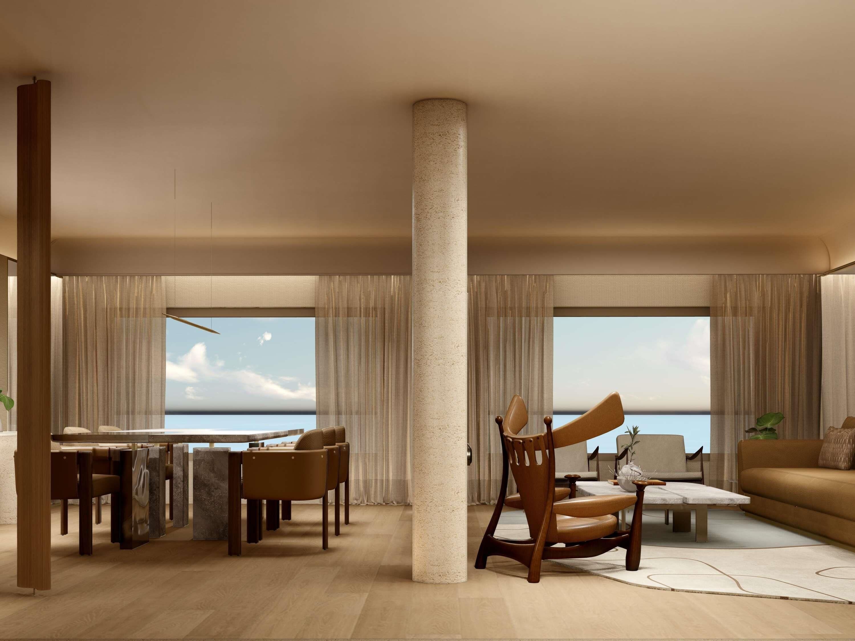A spacious living room with a large window, a dining area, and a view of the sea.