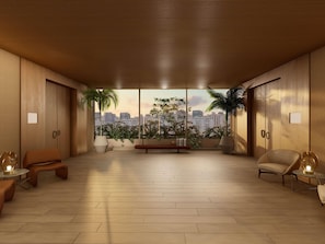 A spacious room with a city view, wooden flooring, and modern furniture.