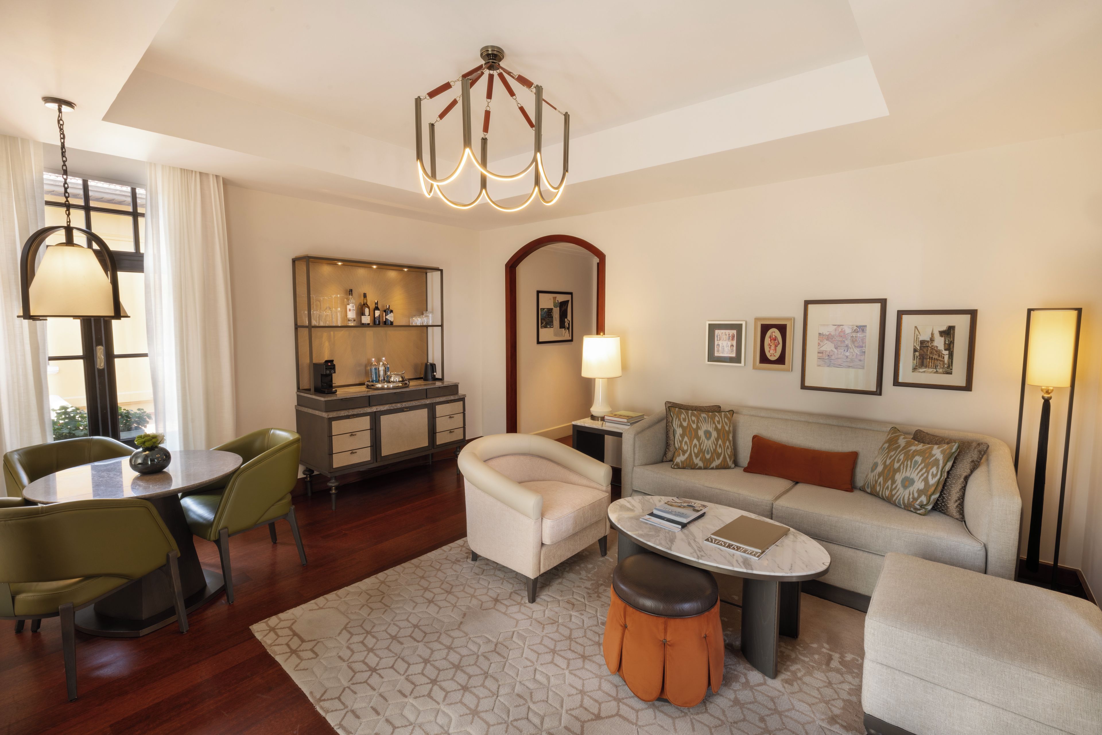A modern living room with a dining area, a bar, and a sofa set.
