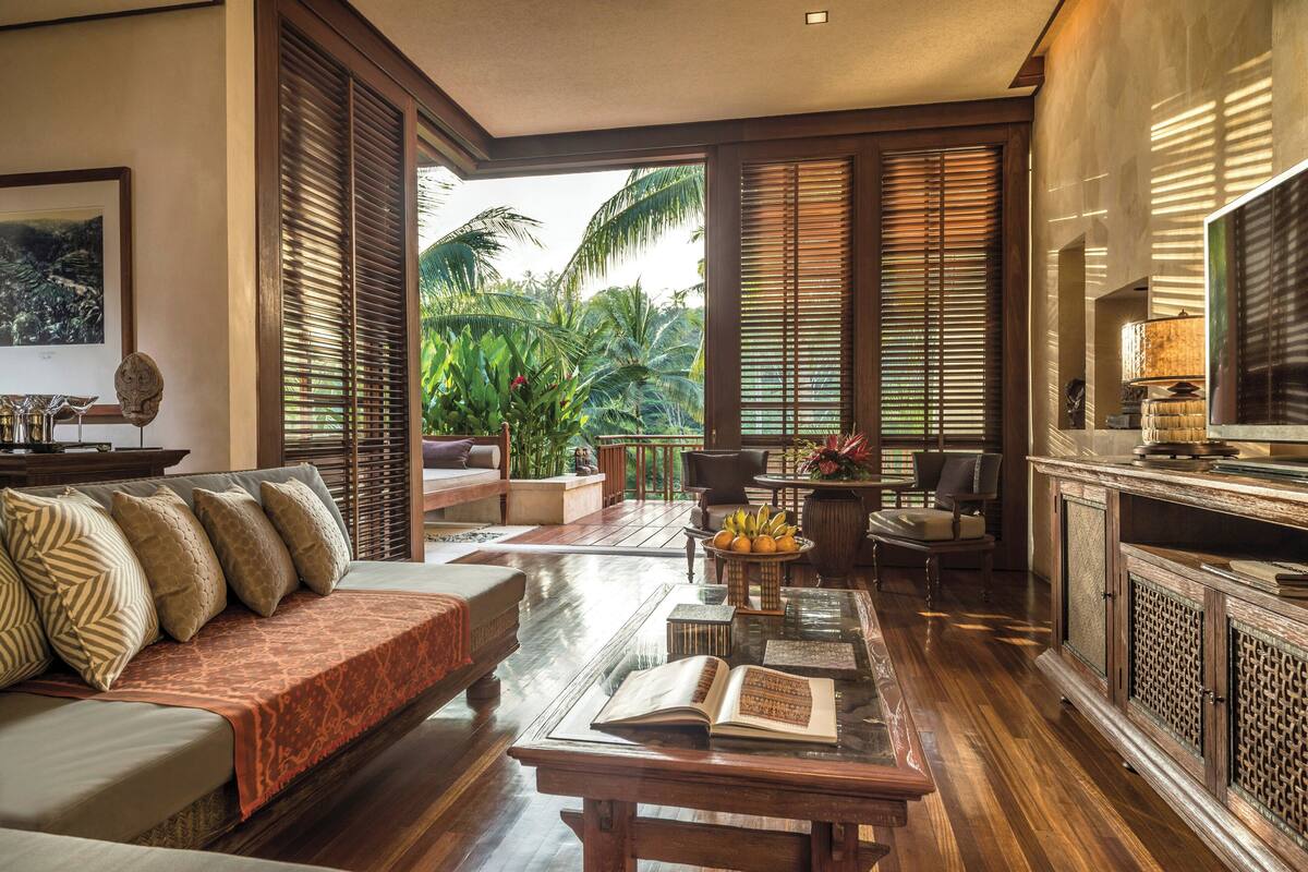 A spacious living room with a sofa, coffee table, and a TV stand.