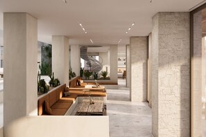 A modern interior with a central seating area, a spiral staircase, and a view of the outdoors. - Golden Beach Tinos (Tinos)