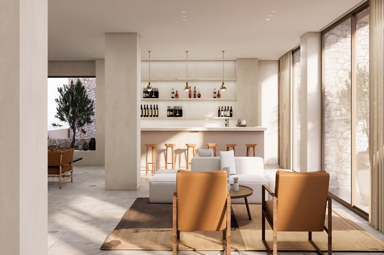 Una sala de estar moderna con un sofá, sillones y una vinoteca.