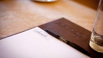 A notebook with the text "Lakeside Hotel & Resort Centre" and a pen on top of it.