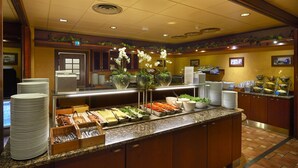 A buffet setup with various food items, plates, and serving utensils. - Scandic Tampere Koskipuisto (Tampere)