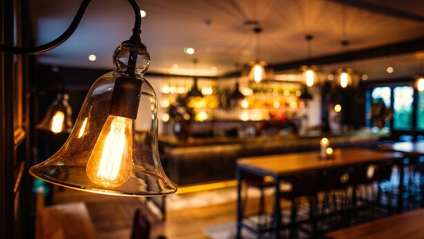 A bar area with hanging light fixtures and a bar counter. - Avon Gorge by Hotel du Vin (Bristol)
