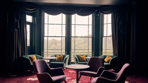 A room with large windows, green sofas with yellow pillows, and a round table in the center. - Avon Gorge by Hotel du Vin (Bristol)