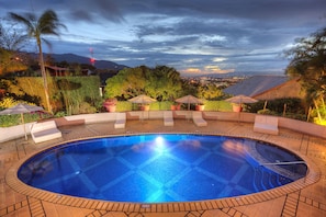 A circular swimming pool with a tiled edge, surrounded by lounge chairs and umbrellas. - Alta Las Palomas Hotel  (Santa Ana)