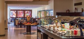 Enjoy a delicious breakfast at our hotel's buffet, featuring a variety of food and beverages.