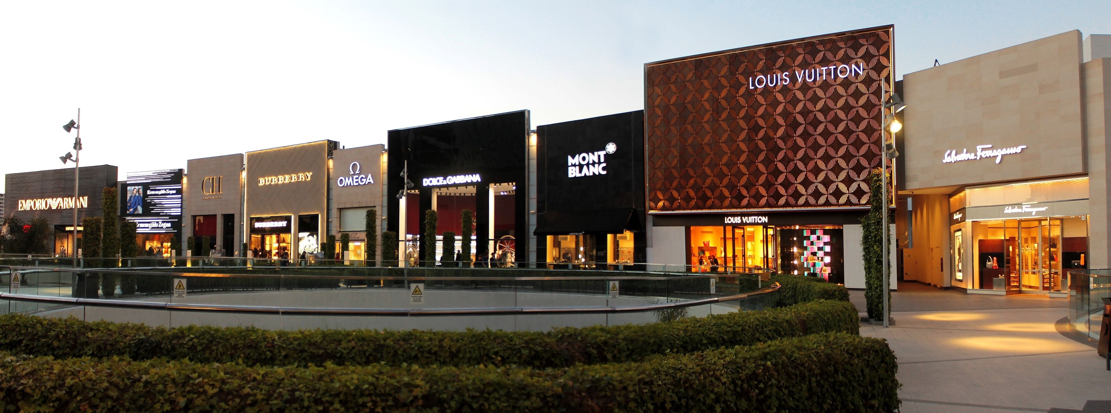 A shopping mall with luxury brand stores like Emporio Armani, BUBBERRY, OMEGA, MONT BLANC, and LOUIS VUITTON.