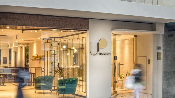 A modern interior with a glass facade, a reception area, and a visible number "1873". - Up Viamonte Hotel (Buenos Aires)
