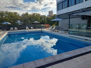 Outdoor pool, open 11:00 AM to 7:00 PM, pool loungers