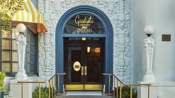 A building entrance with a blue archway, a sign reading 'Graduate Berkeley 2600', and a 'Durant' sign on the wall.