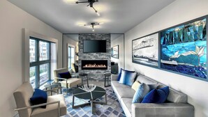 A modern living room with a fireplace, comfortable seating, and large windows. - The Insignia Hotel, Sarnia, a Tribute Portfolio Hotel (Sarnia)