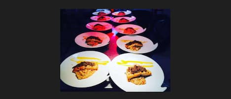 A table with plates of food, each with a different dish and garnish.