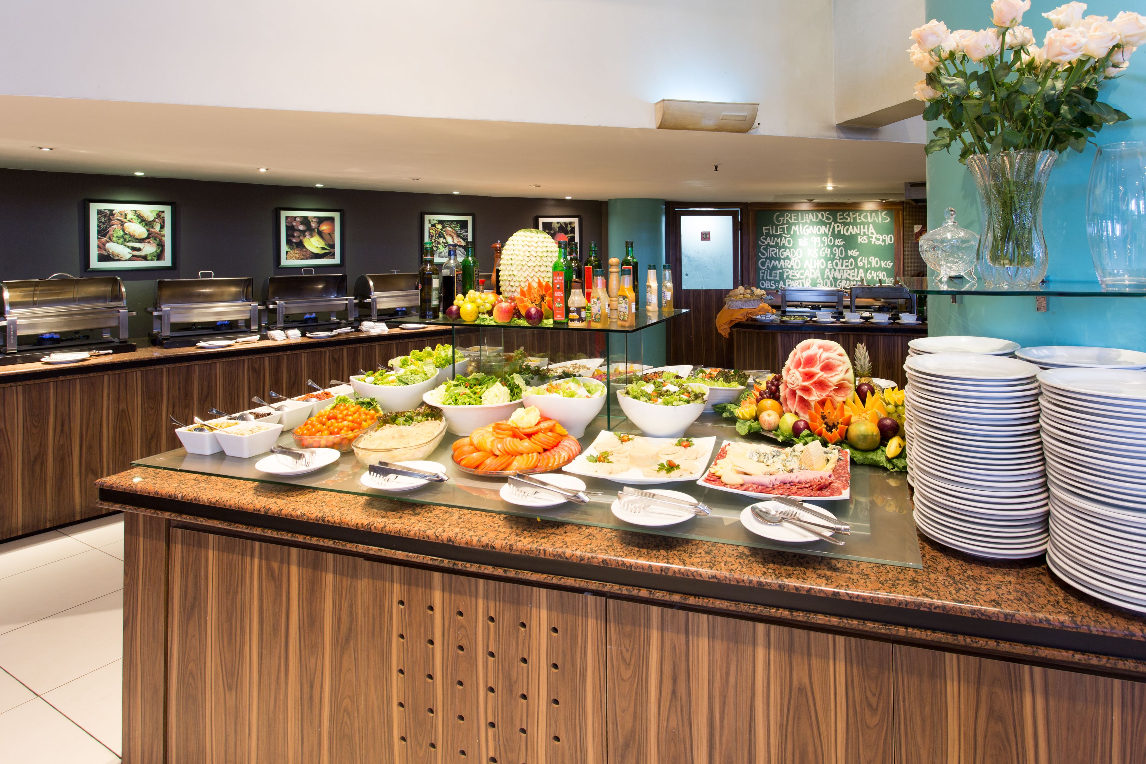 A buffet with various food items and a glass display case.