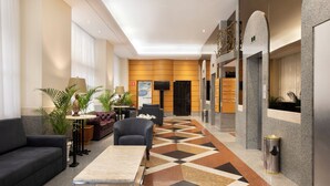 A modern lobby with a geometric patterned floor, seating areas, and a reception desk. - Windsor Guanabara Hotel (Rio de Janeiro)