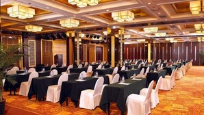 A conference room with rows of tables and chairs, equipped with nameplates and water bottles. - Gloria Plaza Hotel Shenyang (Shenyang)