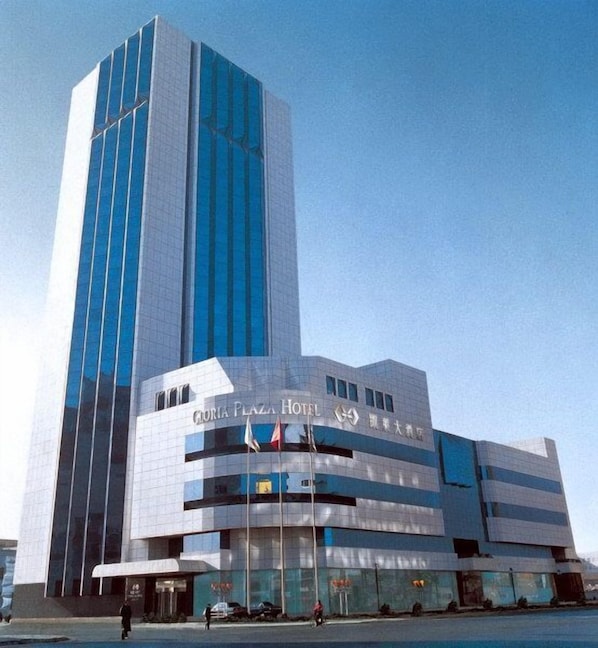 A modern hotel with a prominent vertical tower and a horizontal building section.