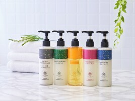 Five bottles of Hotel Granvia Kyoto's skincare products on a marble surface.