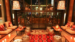 A well-lit lounge area with sofas, tables, and decorative stools. - The Westin Westminster (Westminster)