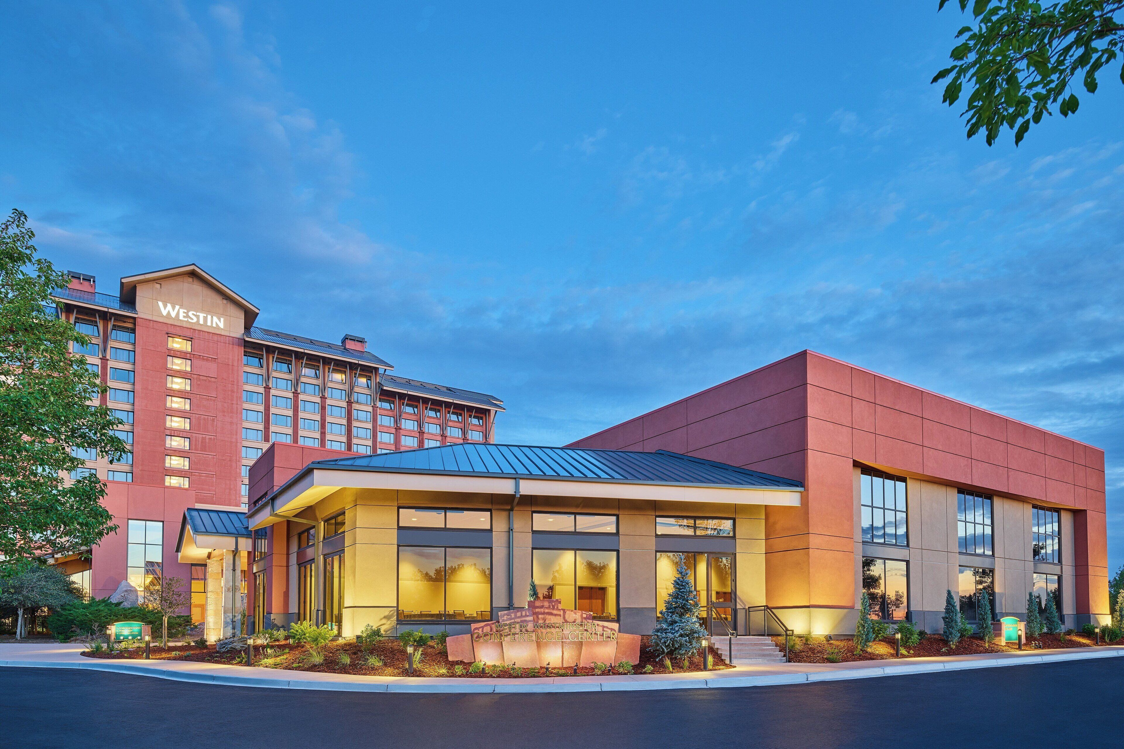 A Westin hotel with a modern facade, large windows, and a well-lit entrance.