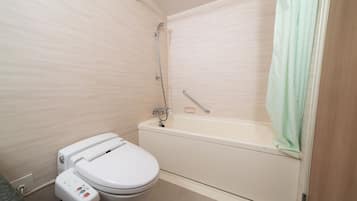 A modern bathroom with a toilet, a bathtub, and a shower.