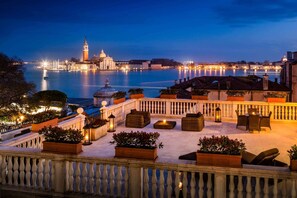 A terrace with outdoor seating, a railing, and potted plants. - Baglioni Hotel Luna - The Leading Hotels of the World (Venice)