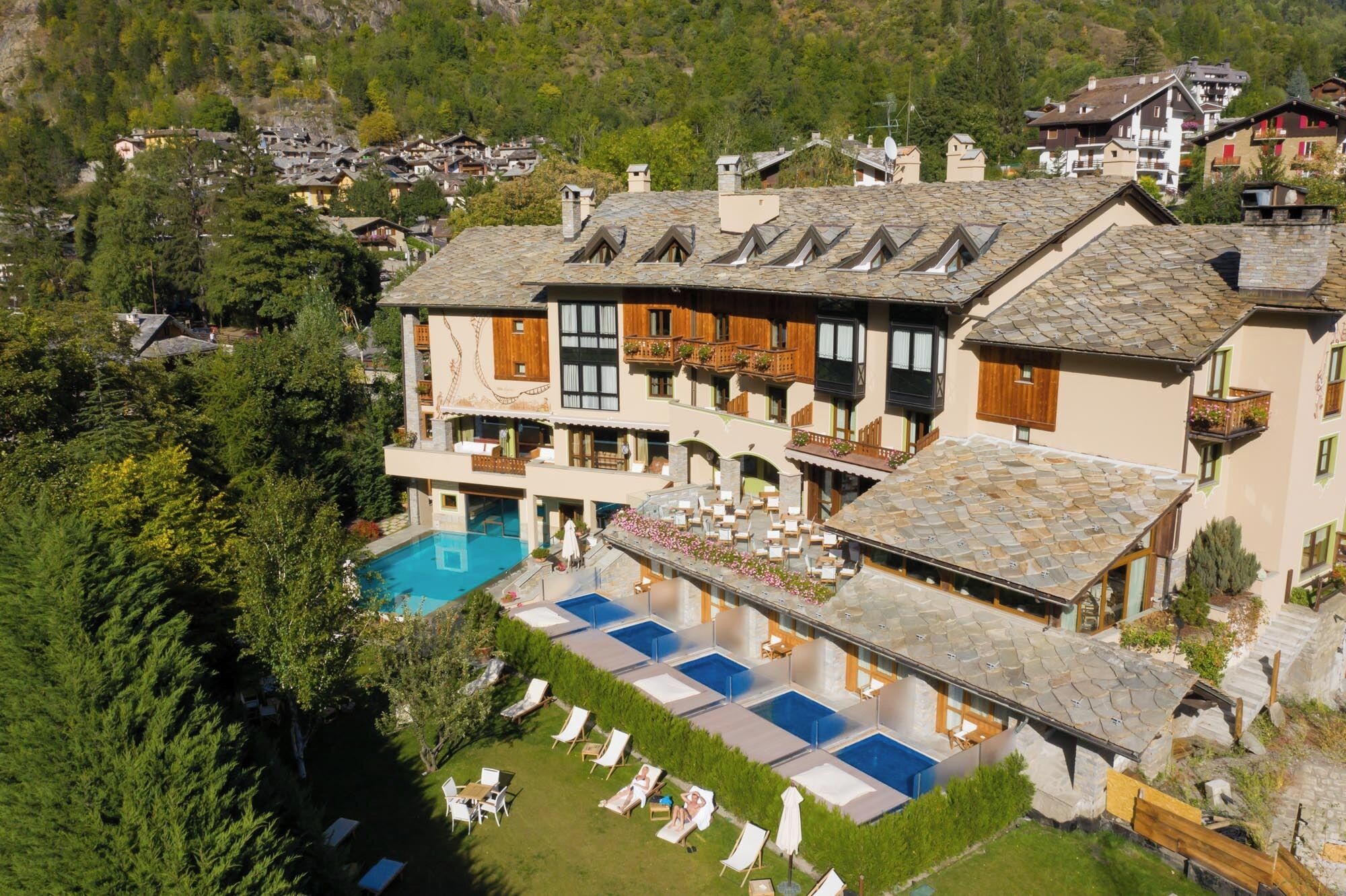 A large building with a swimming pool and multiple balconies.