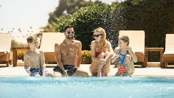 Guests can enjoy a refreshing swim in the pool surrounded by comfortable lounge chairs.