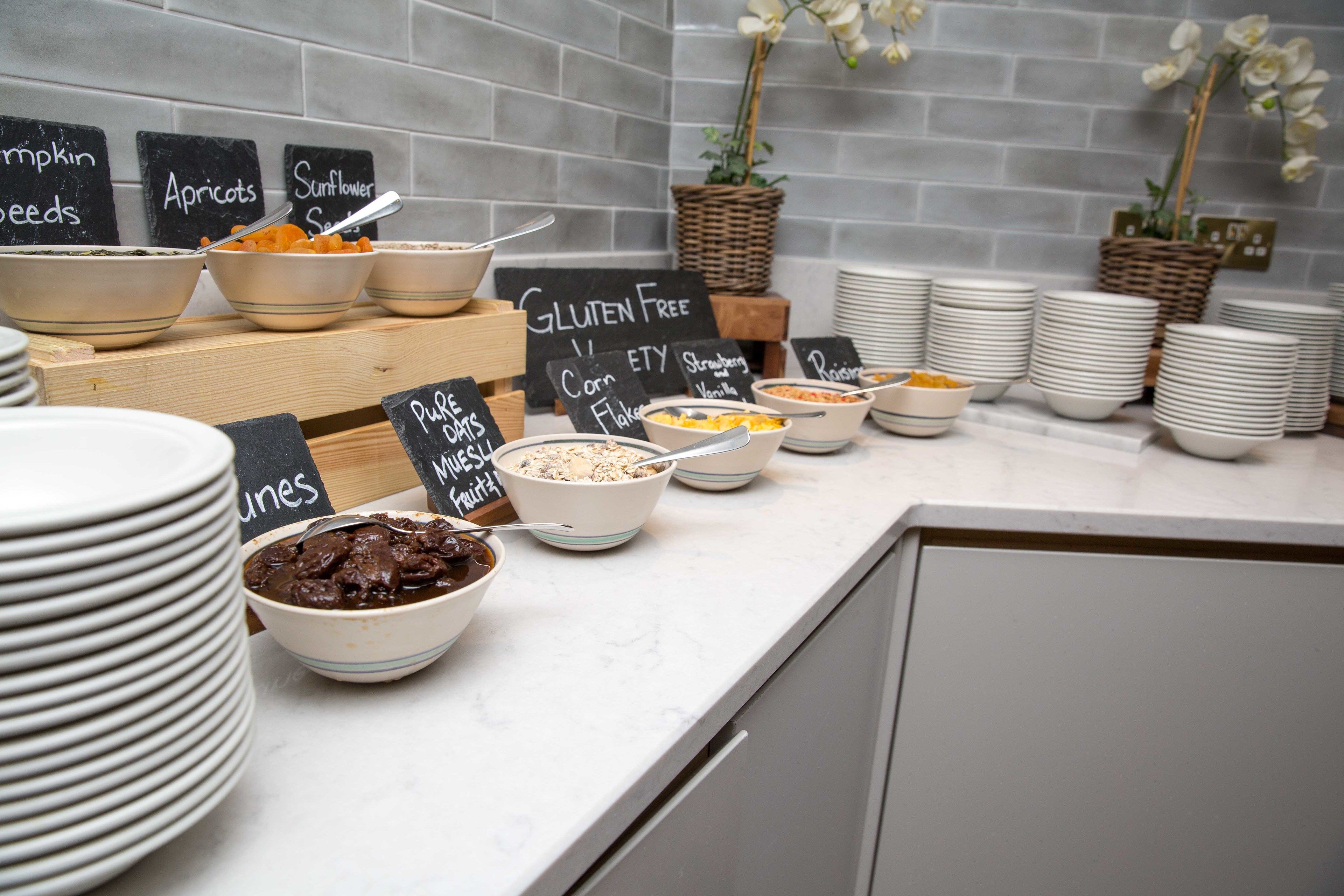A buffet with various gluten-free and fruit options.