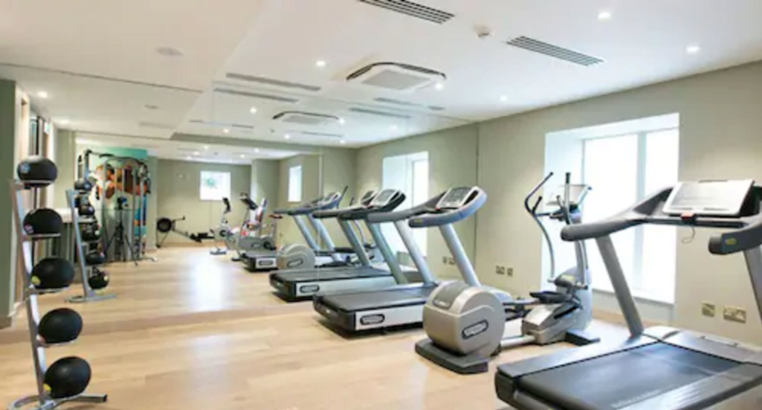 A gym with treadmills, stationary bikes, and weight machines.