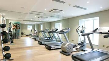 A gym with treadmills, stationary bikes, and weight machines.