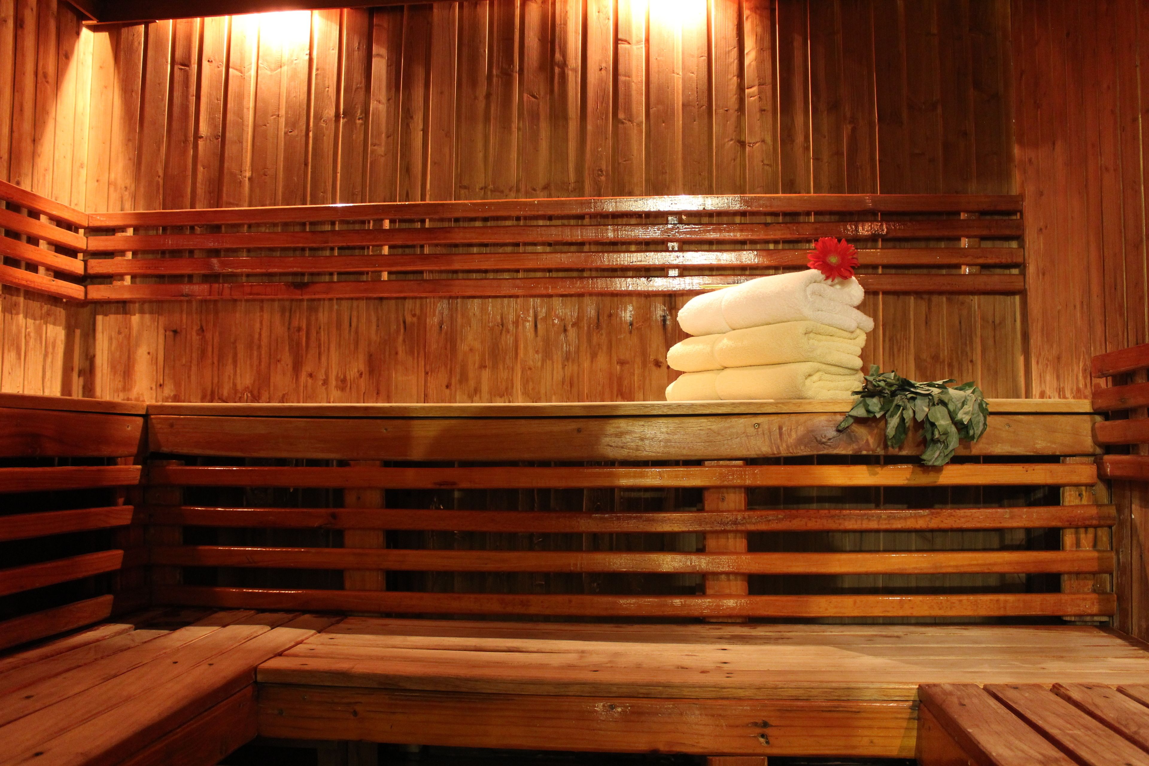 Un banco de madera con toallas y una flor.