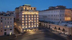 A multi-story hotel with a prominent "BERNINI" sign, featuring a row of uniformly lit windows and a central entrance. - Sina Bernini Bristol, Autograph Collection (Rome)