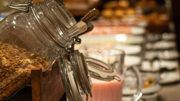 A buffet setup with various food items and containers.