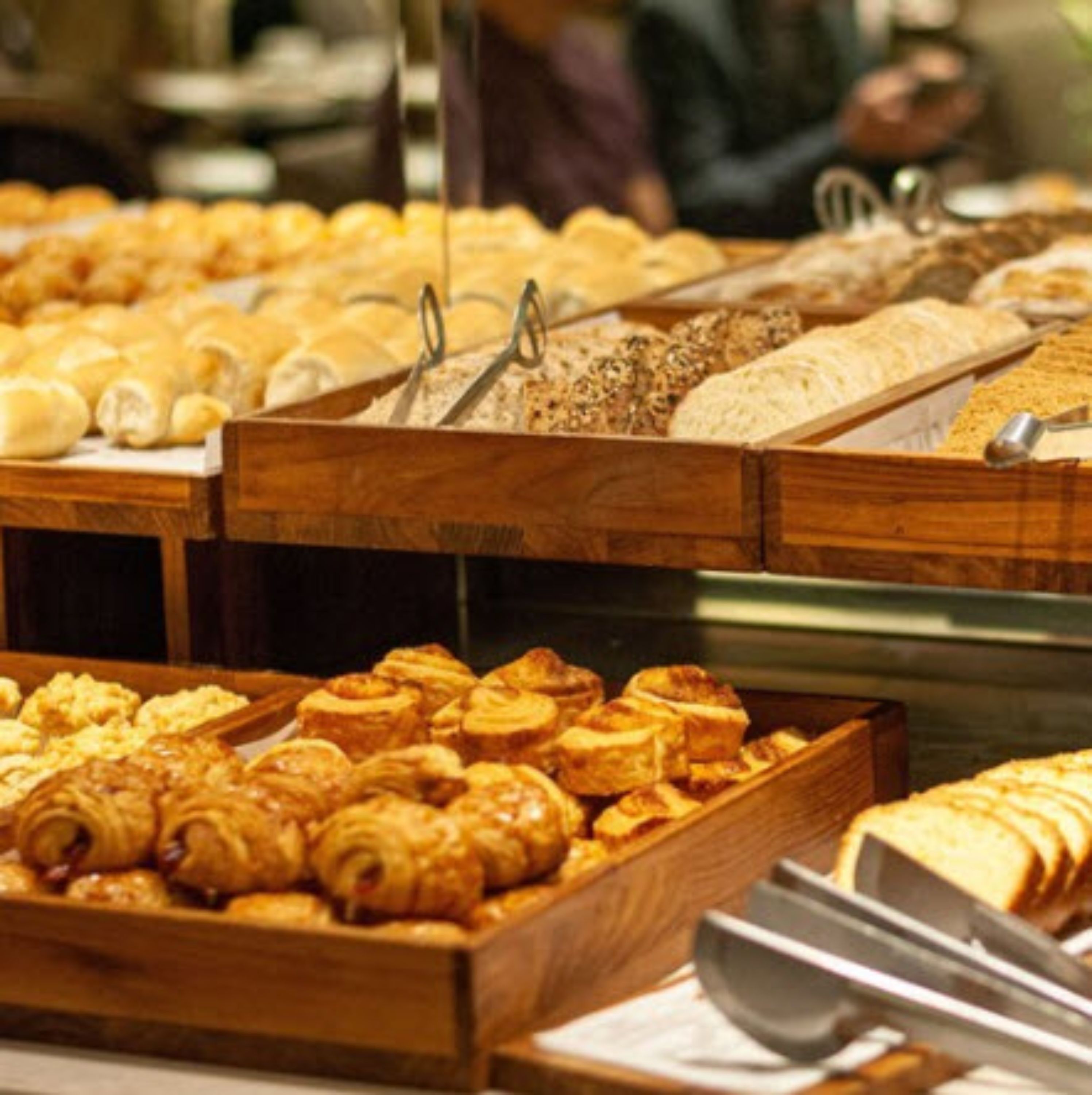 A bakery display with various baked goods.