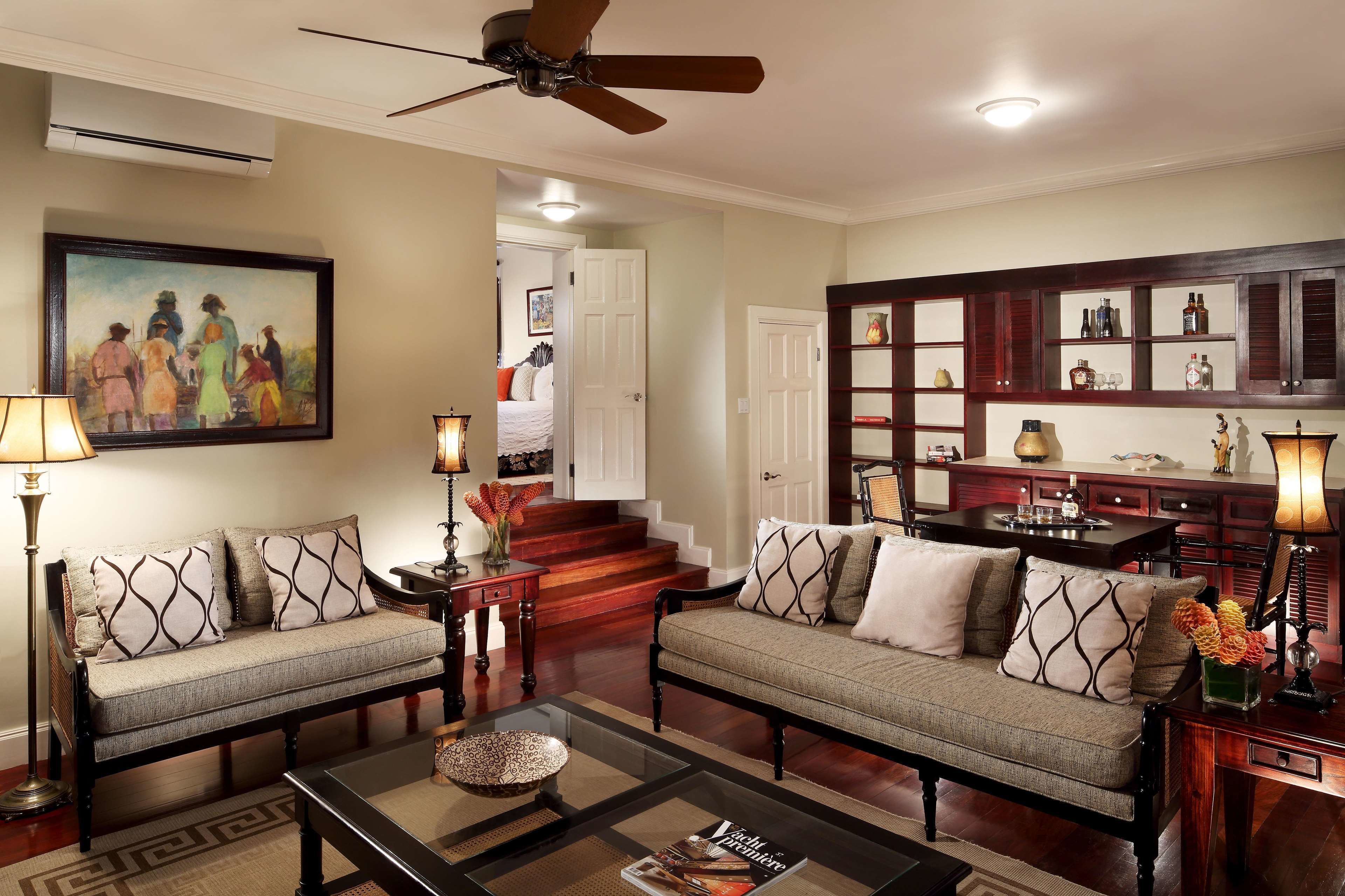 A living room with two sofas, a coffee table, and a painting on the wall.